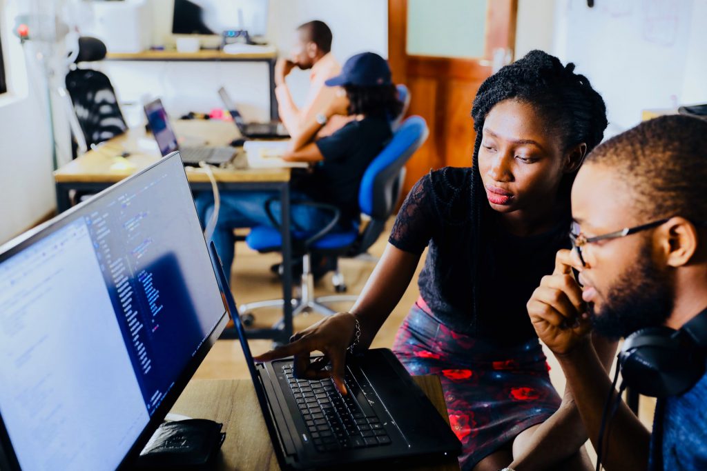 faculty helping student on computer